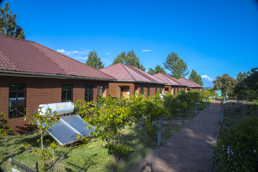 Row of luxury brick cottages with solar panels at Highview Coffee Lodge in Karatu, Tanzania.