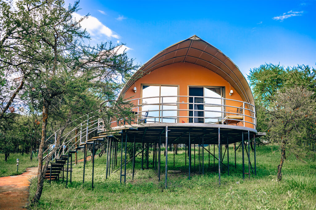 Luxury elevated suite with a private balcony at Ngorongoro Safari Lodge, Tanzania.